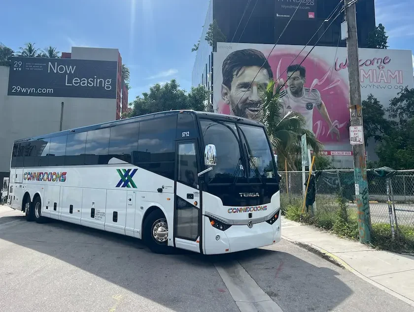 Connexxions charter bus in Miami Wynwood with Lionel Messi mural