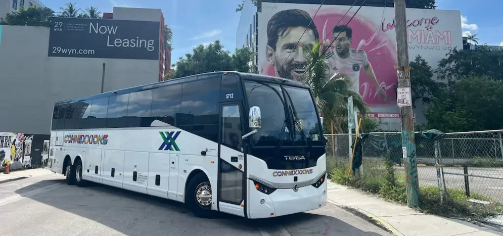 Connexxions charter bus in Miami Wynwood with Lionel Messi mural in the background